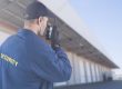 A security guard talks on a walkie talkie