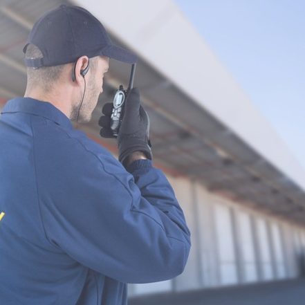 A security guard talks on a walkie talkie