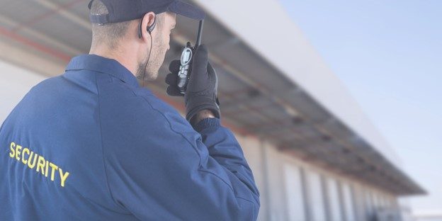 A security guard talks on a walkie talkie