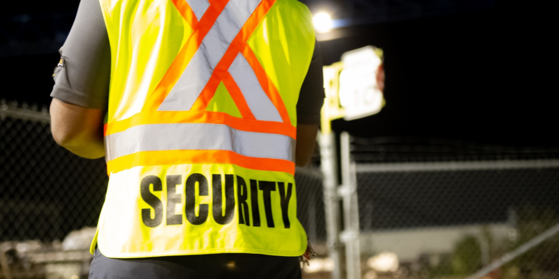 emergency_response_planning Security guard patrolling in fenced commercial area