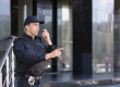 Male security guard using portable radio transmitter outdoors
